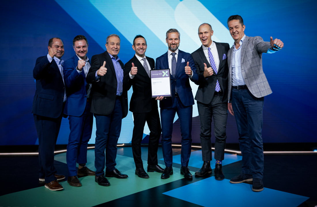 Volupe accepts the Top European Partner for Customer Support award on stage with Siemens at the Converge partner summit, 2023
